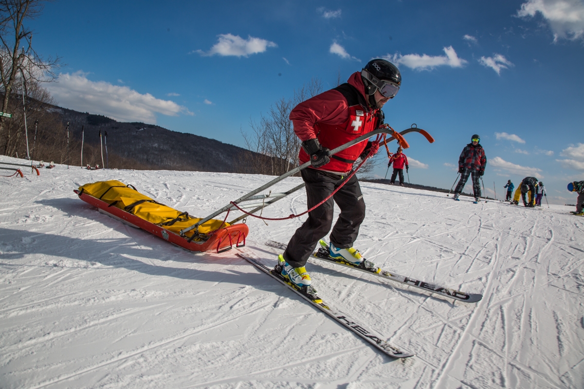 Ski patrol pulling rescue sled