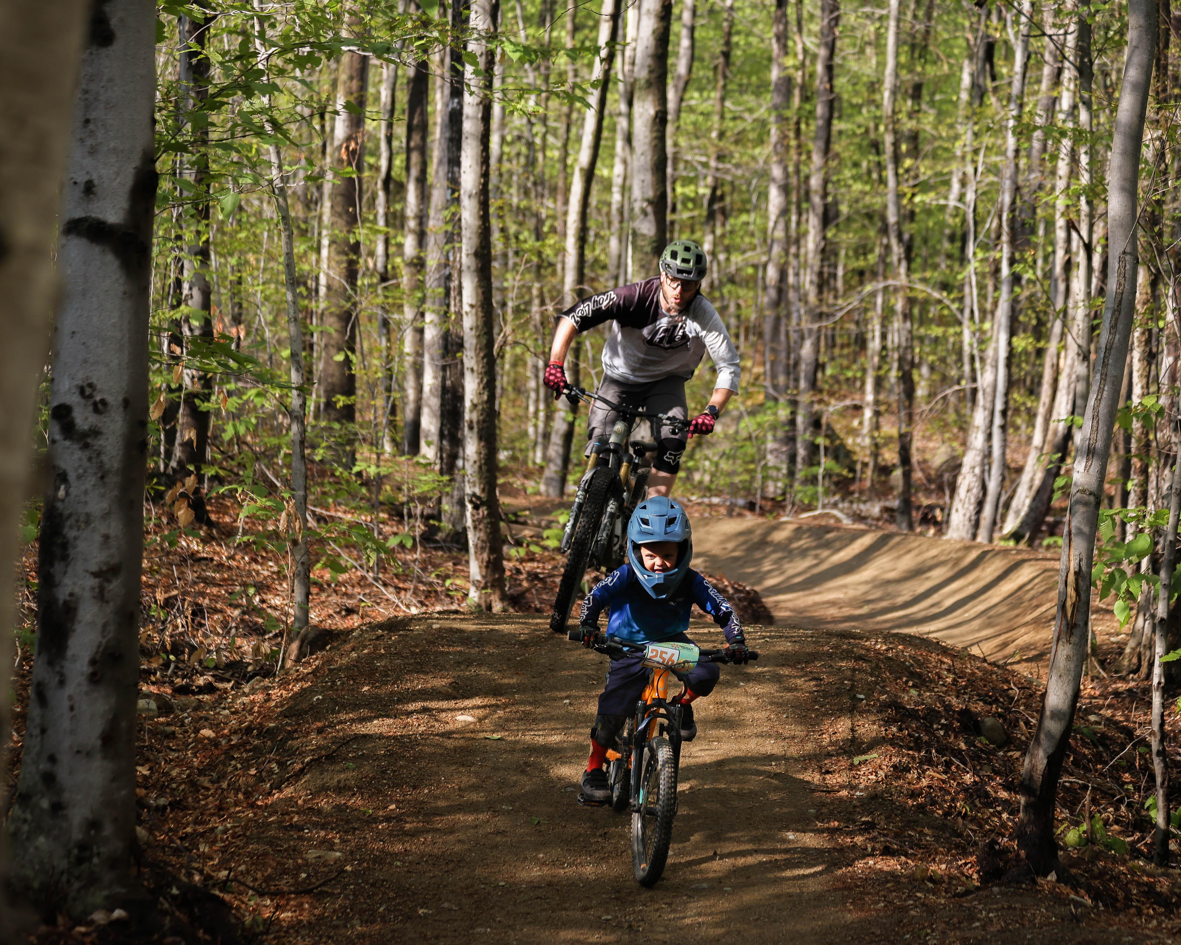 Father and young son riding flow trail