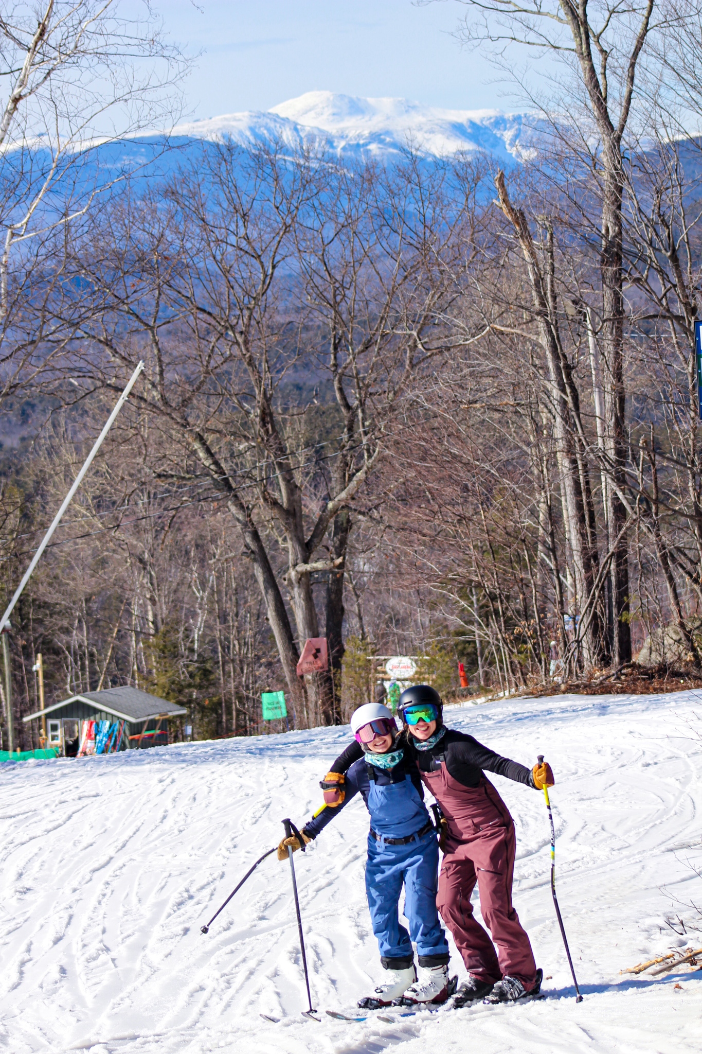 Skiers posing for picture above race shack