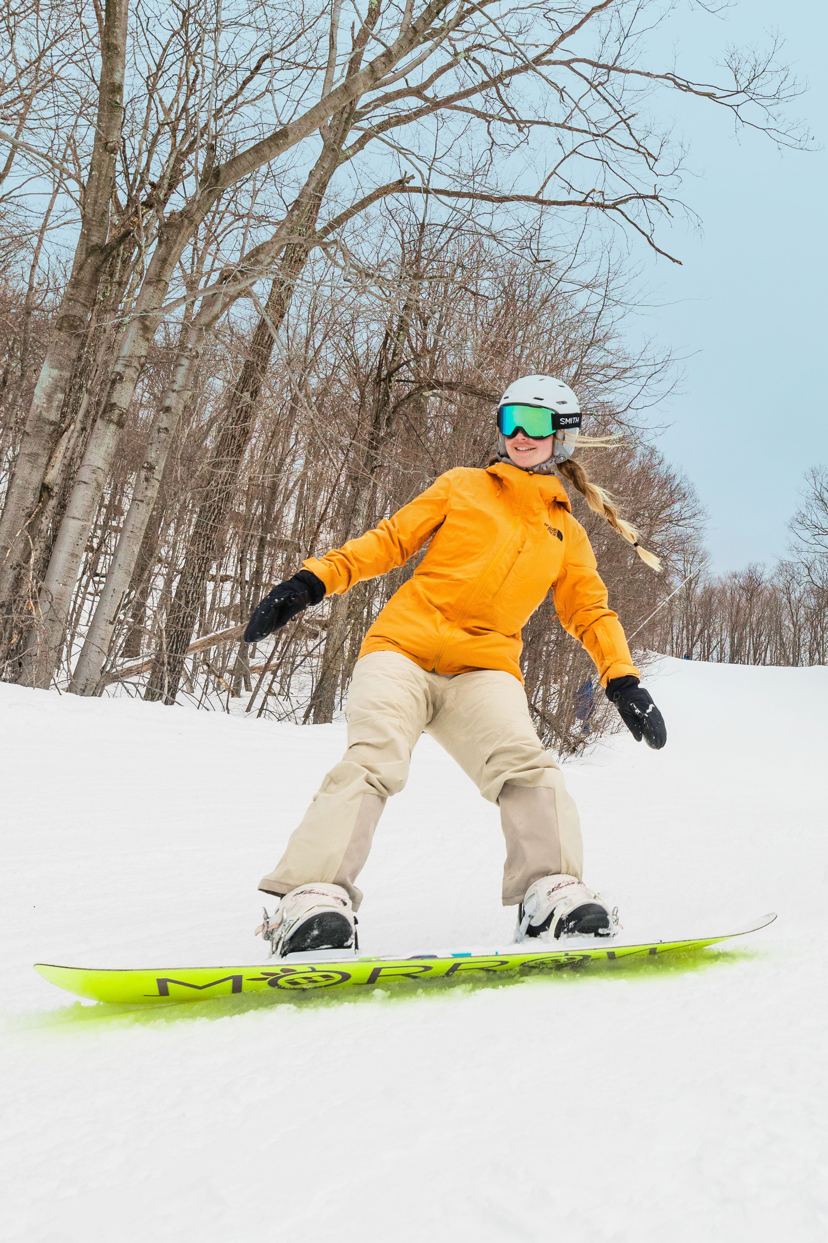 Snowboard Female vertical, orange jacket