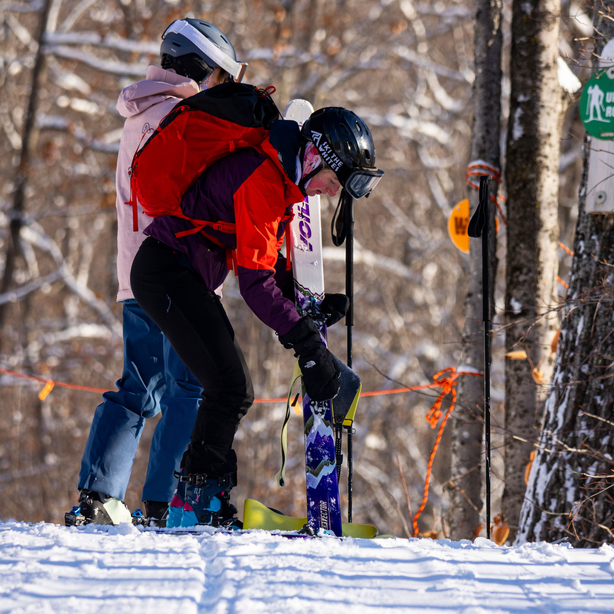 Uphill skier with skins, red jacket