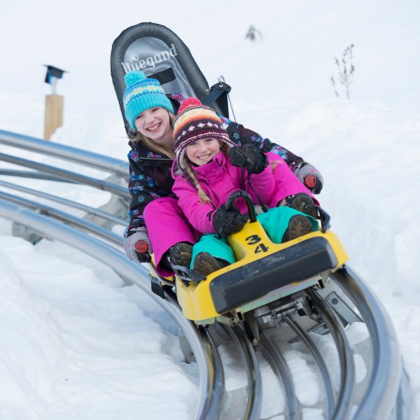 Mountain Coaster two kids in winter gear